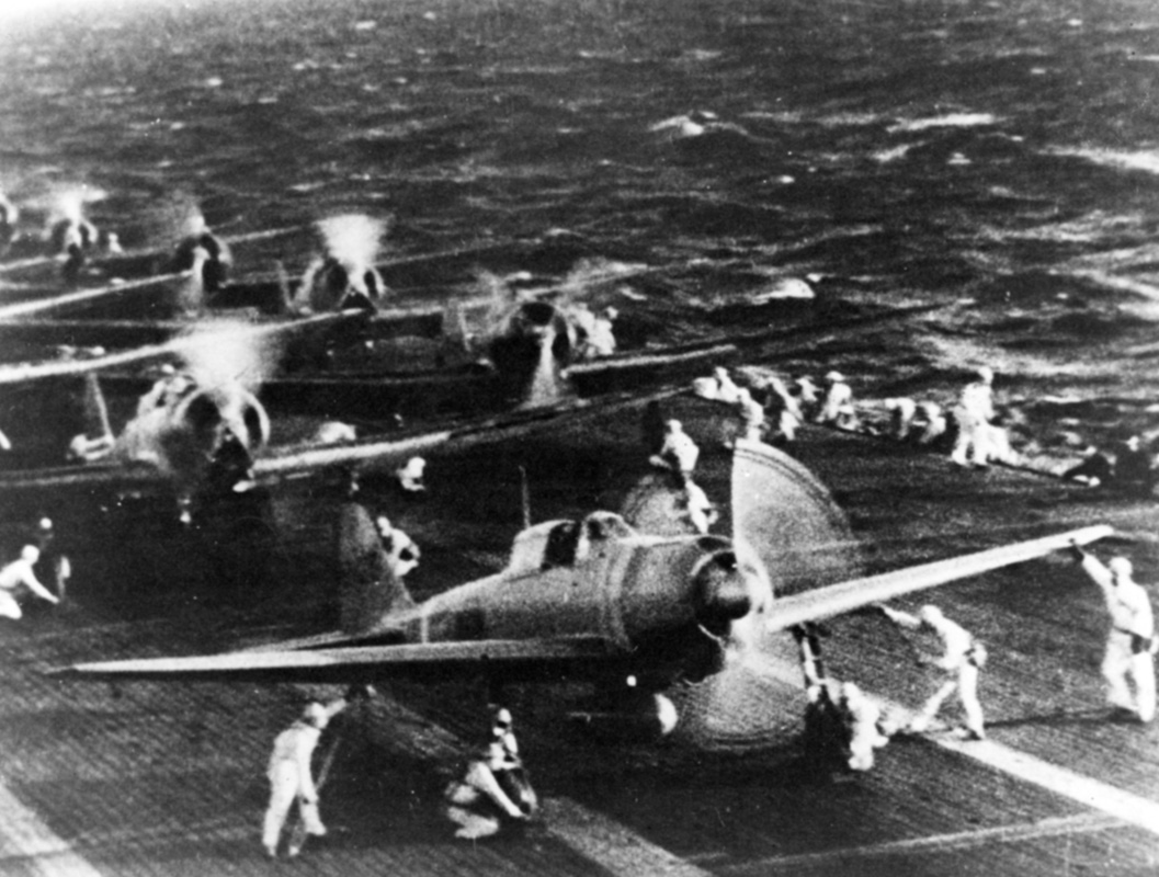 Japanese naval aircraft prepare to take off from an aircraft carrier (reportedly <em>Shokaku</em>) to attack Pearl Harbor during the morning of 7 December 1941. Plane in the foreground is a Zero Fighter. This is probably the launch of the second attack wave. The original photograph was captured on Attu in 1943.  . Image: Official US Navy photograph collection of the National Archives, Naval History and Heritage Command BD-G-71198.