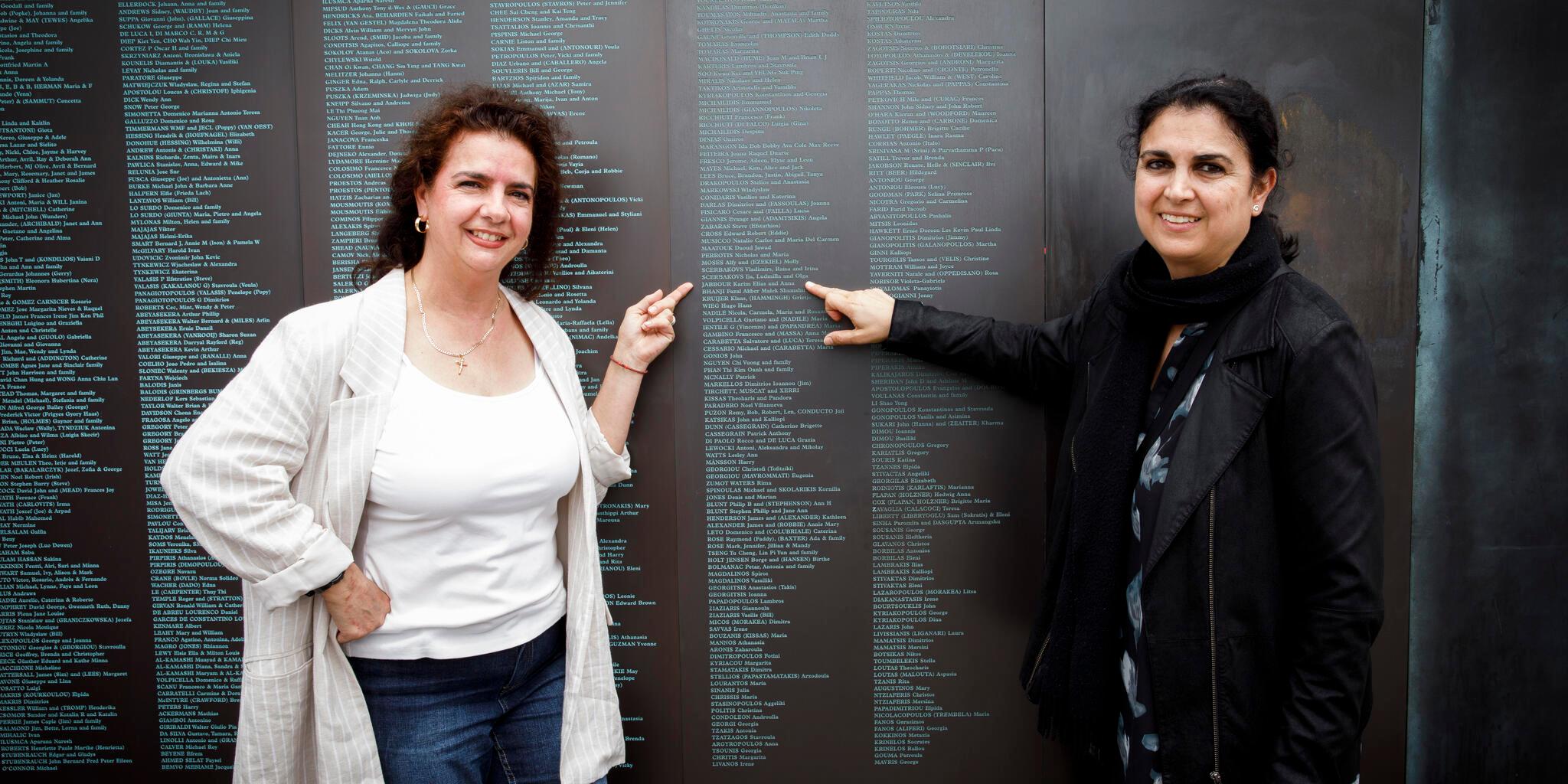 Two people in front of the National Monument to Migration