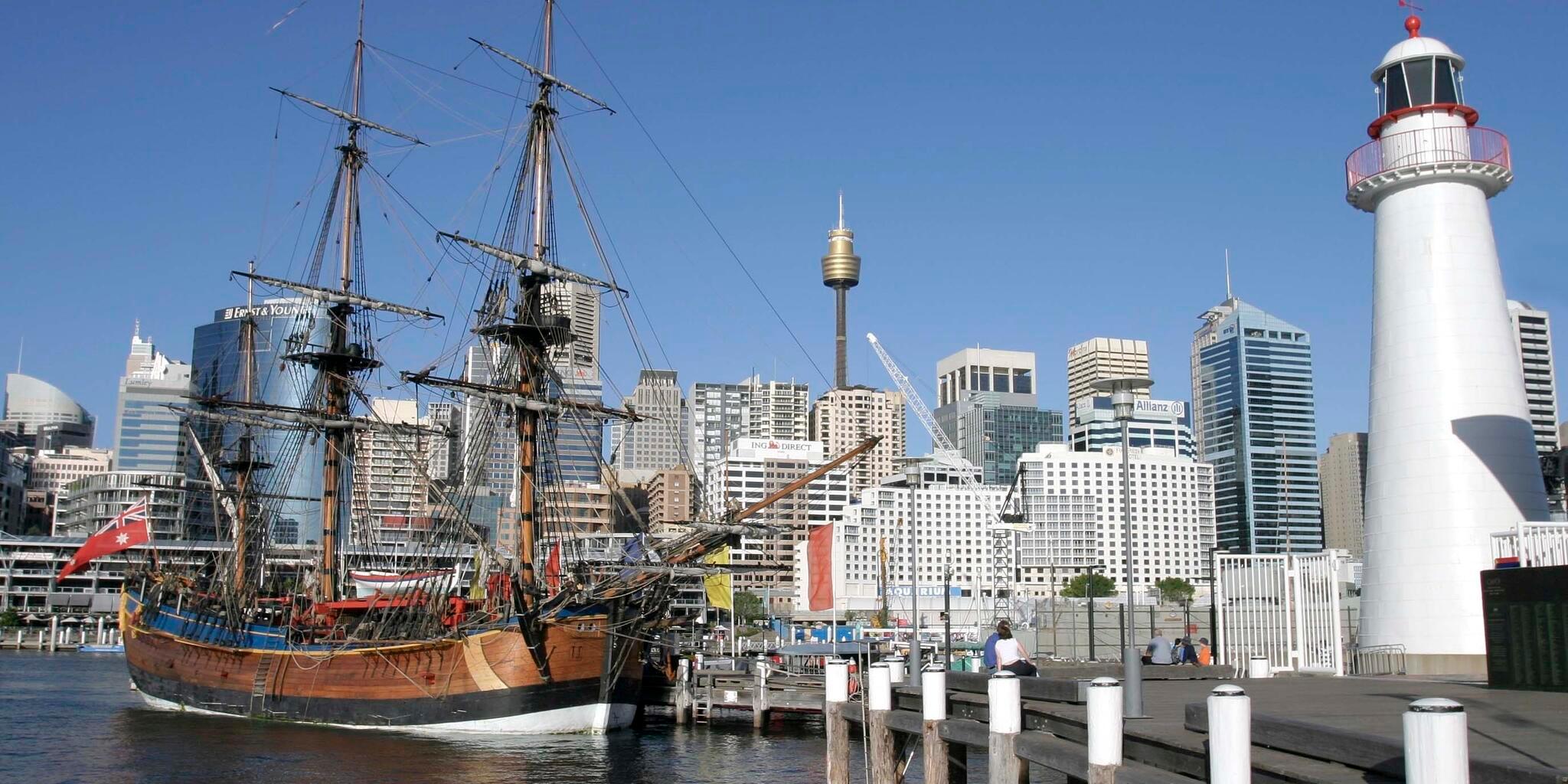 Endeavour at the museum with lighthouse to the right and the city in the background. 