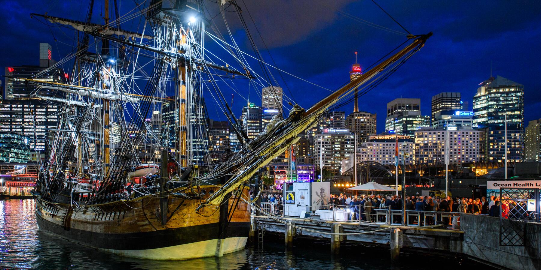 Endeavour at night with city skyline view