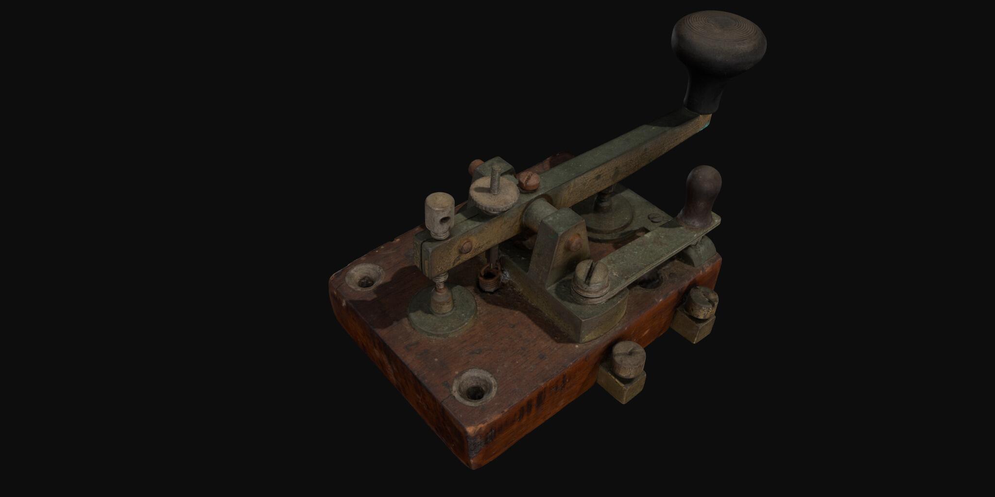 3D model of a telegraph tapping key made from metal which is a dark brown green colour, on a wooden base. 