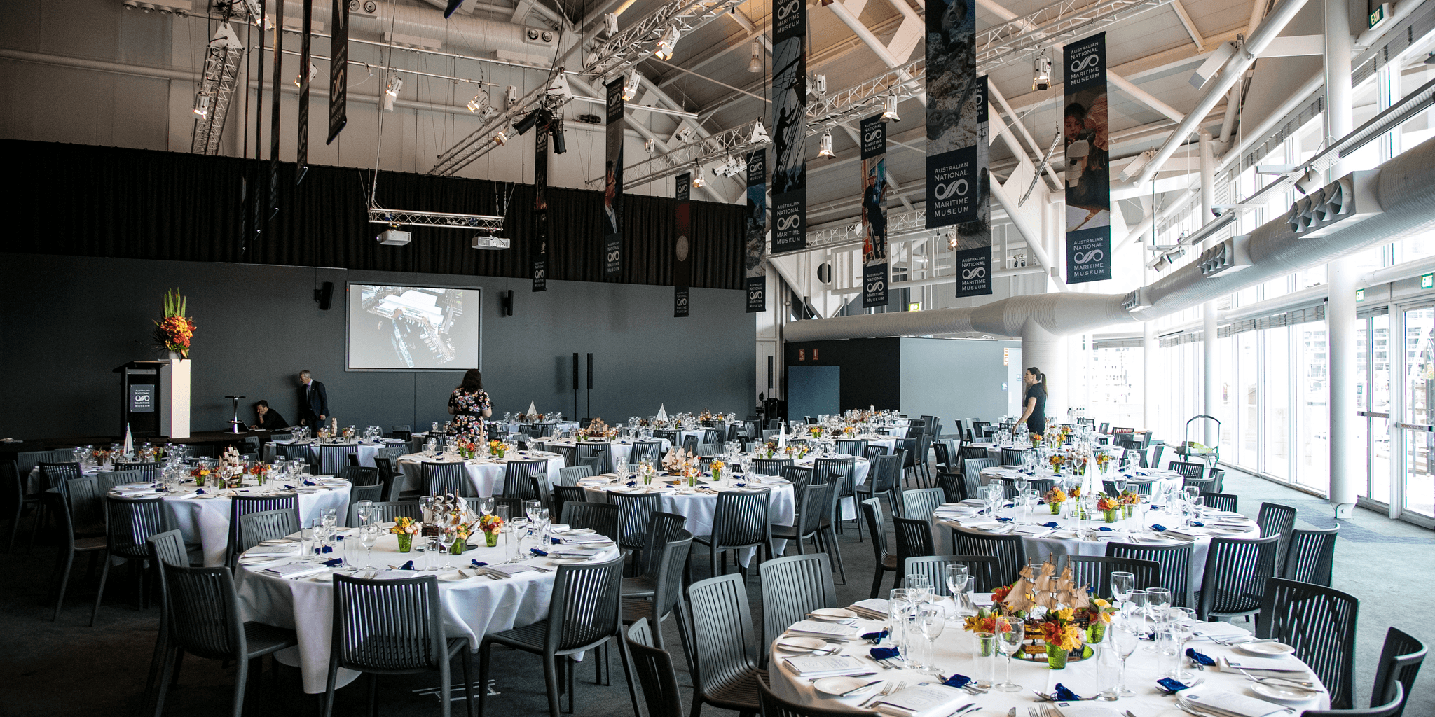 The venue space set with dining tables ready for the start of the event.