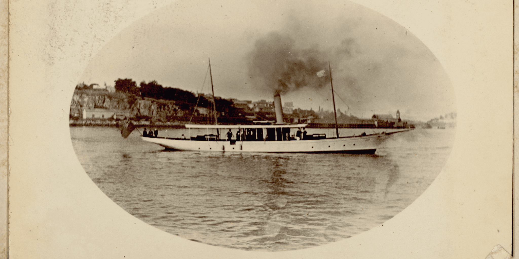 A black and white photo of a steam boat on yellowed paper. 