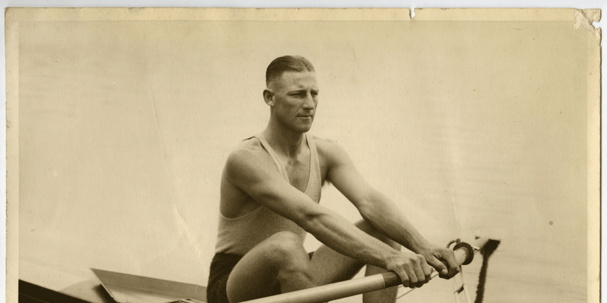 Black and white photo of a man in a row boat