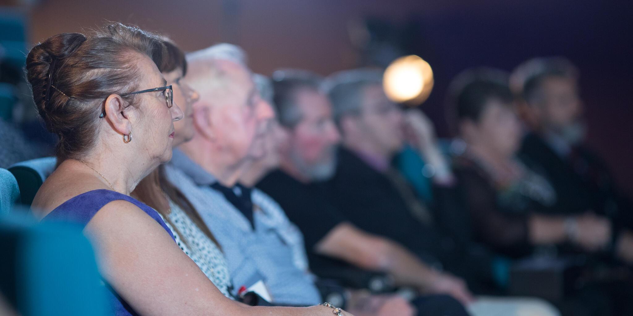 photo of audience members in the museum theatre