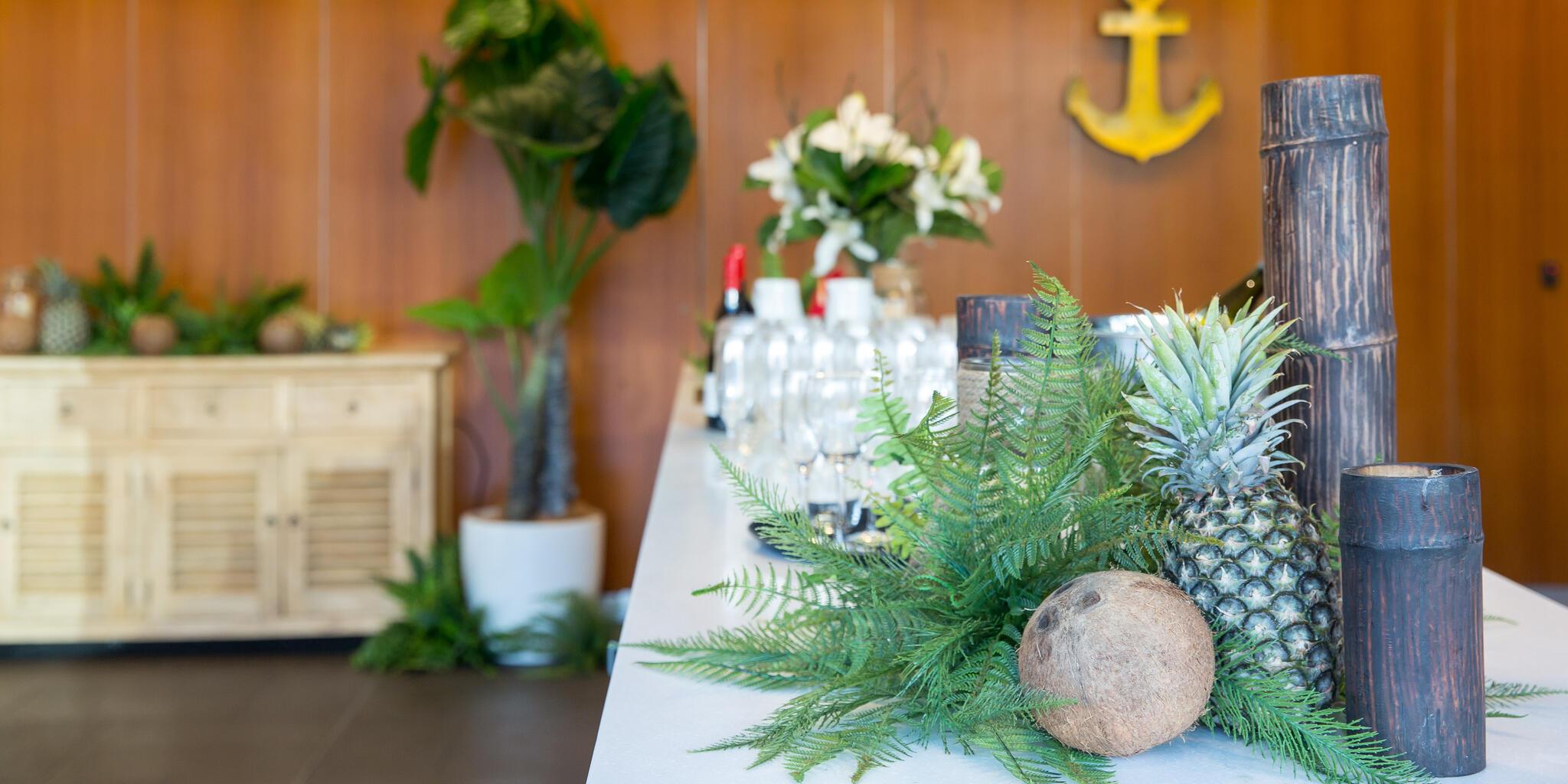 close up photo of natural decorations on a white table cloth, with a wooden wall in the background.