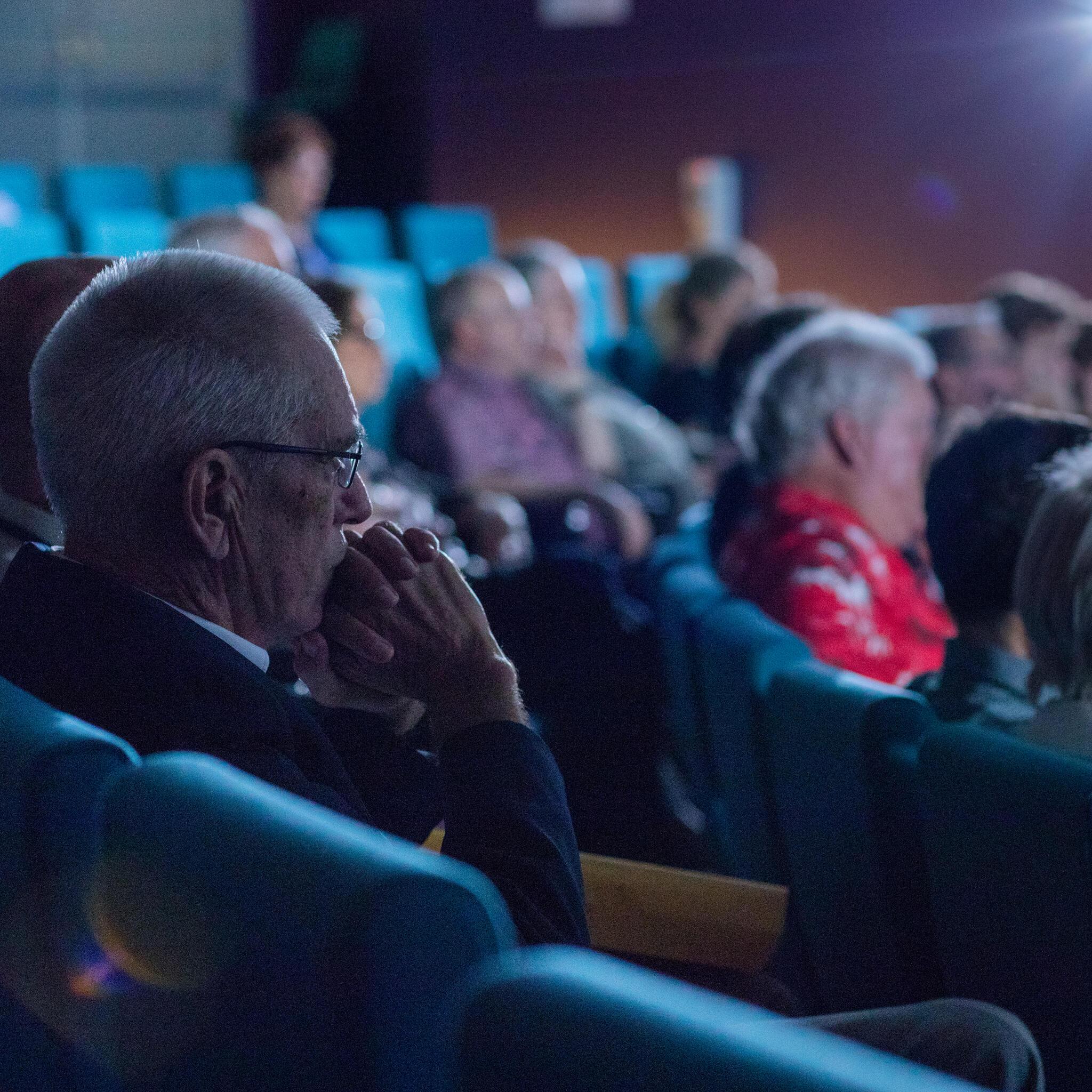 Audience of event guests seated in the theatre