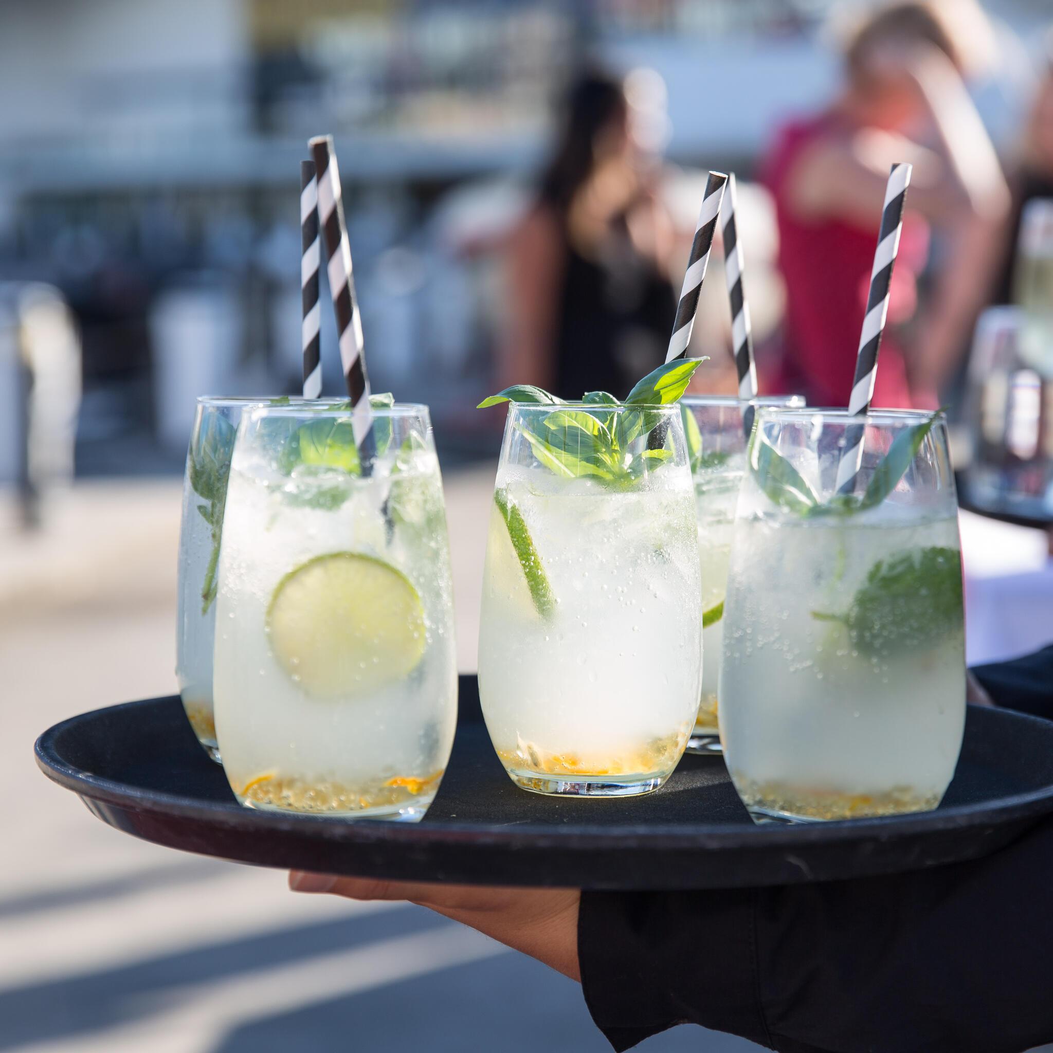 close up photo of lemonade glasses on a tray with a blurred background 