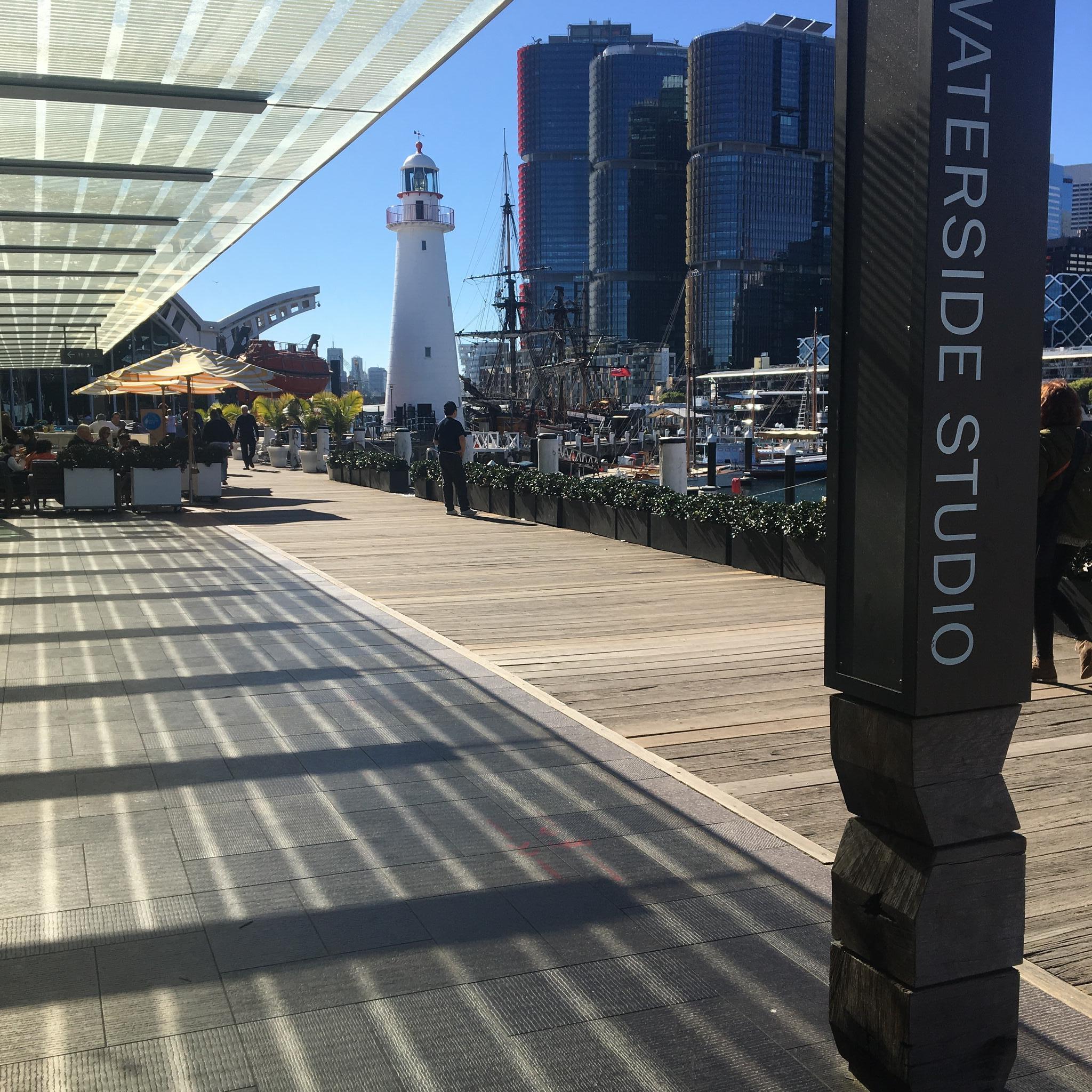 photo of museum boardwalk with Sydney skyline in the background