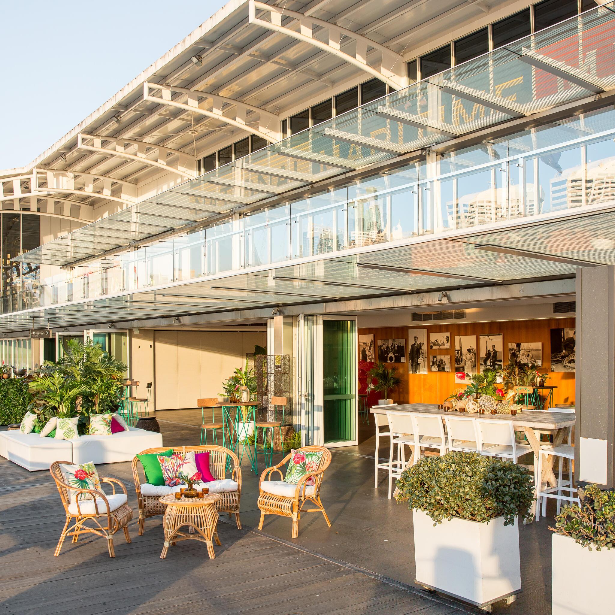 photo of an indoor outdoor space with event furniture and plants on a sunny day