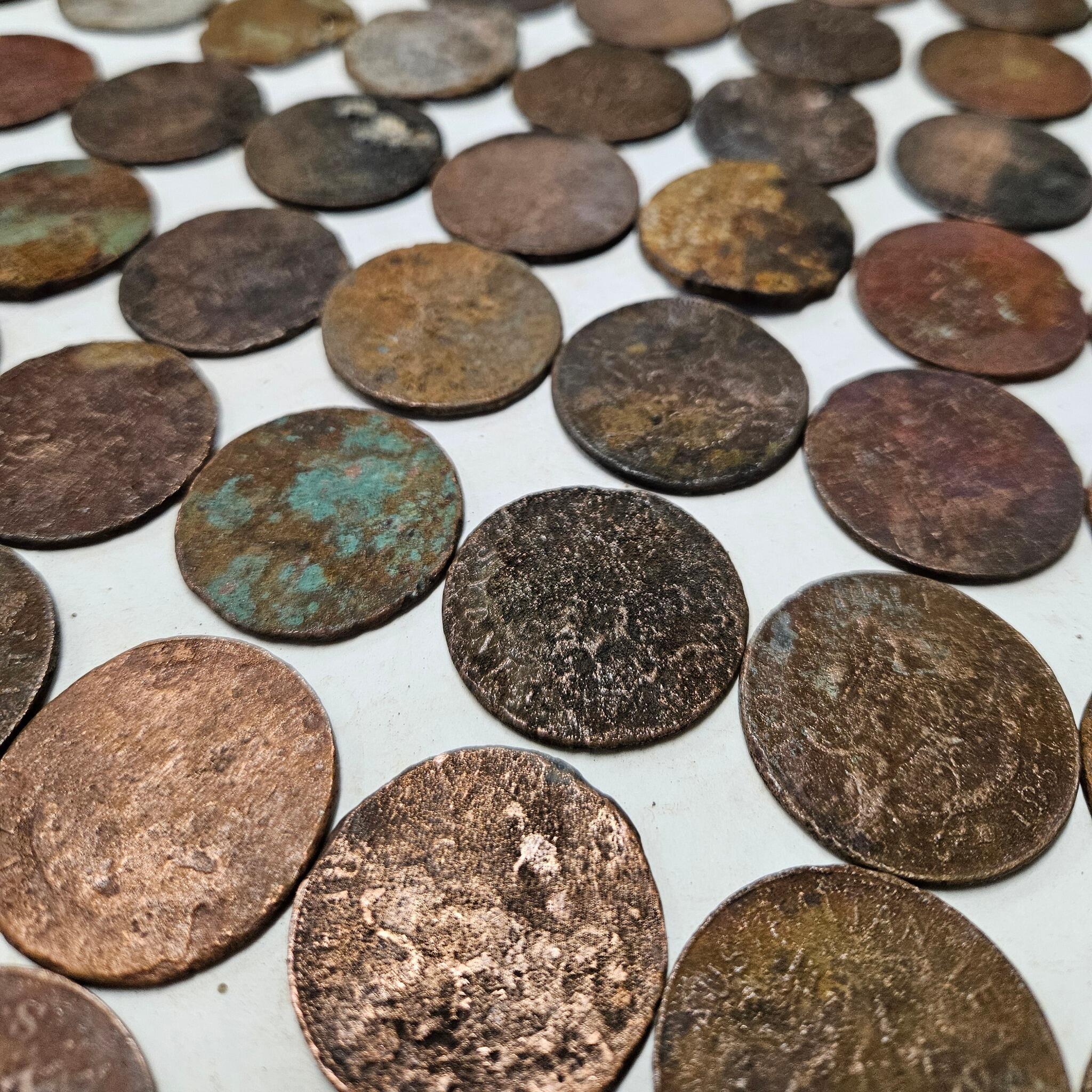 photo of many old coins in diagonal rows