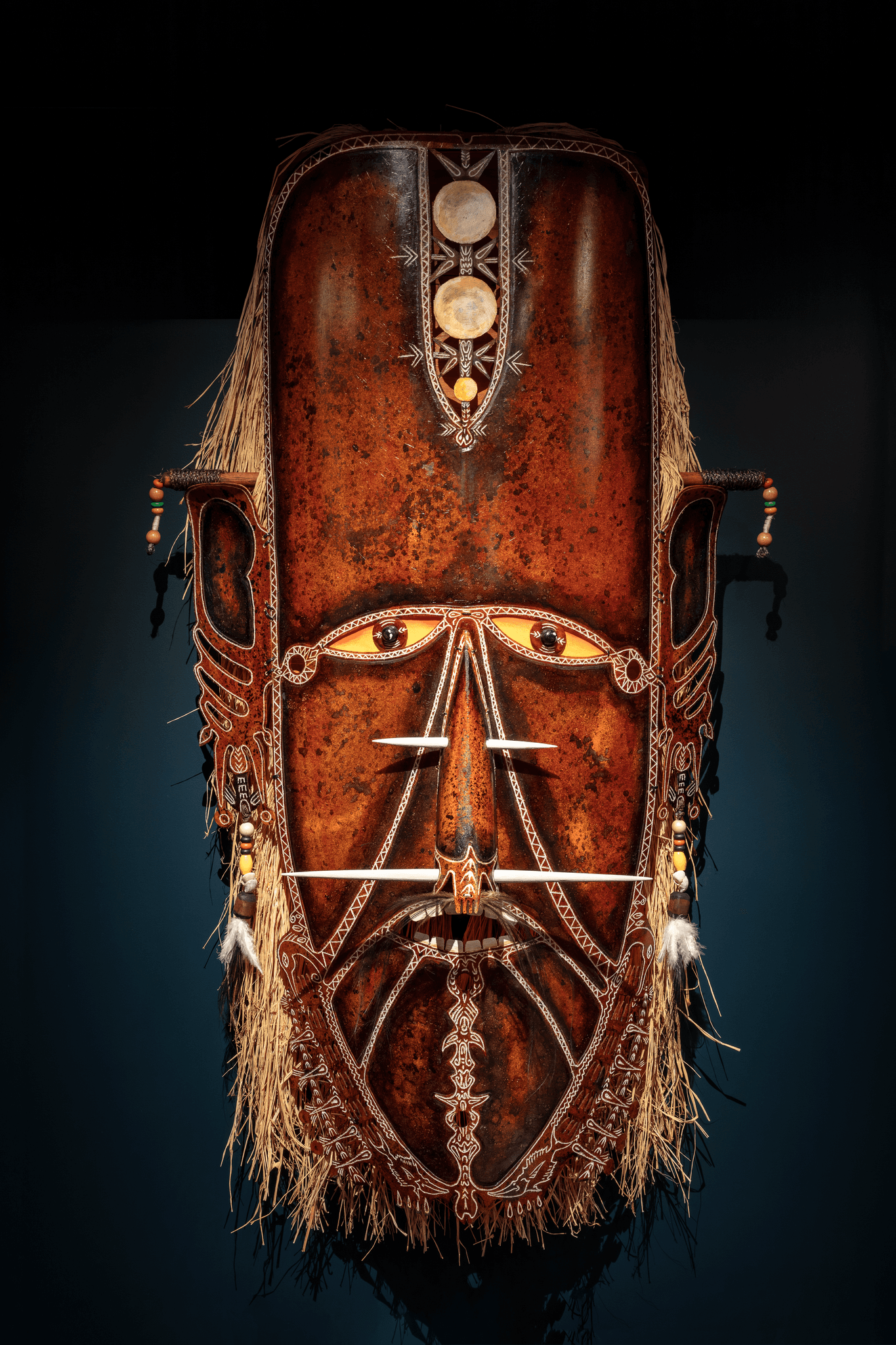 Large fibreglass mask with raffia, pearl and shell ornaments made by artist Alick Tipoti.