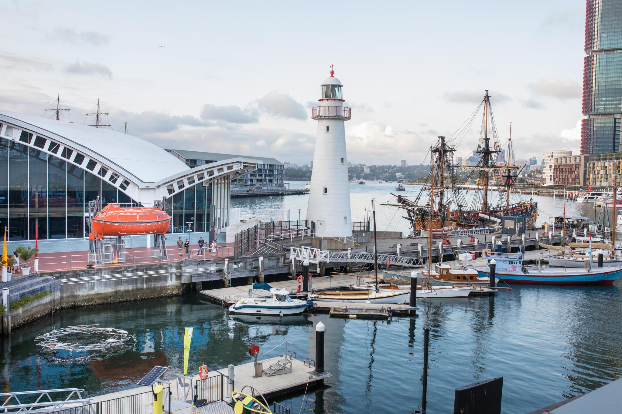 An exterior view of the museum showcasing the waterfront surrounding the lighthouse.